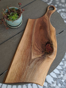 walnut charcuterie board with handle.